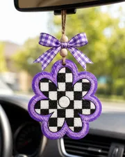 Handmade checkered daisy freshie car air freshener with a white daisy flower on a retro black and white checkerboard pattern, hanging from a ribbon.