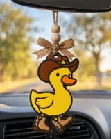 Handmade cowboy duck car freshie, a scented aroma bead air freshener shaped like a rubber ducky wearing a western cowboy hat, hanging from a car rear-view mirror.