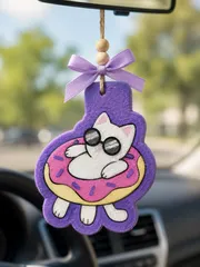 Handmade cat-shaped car freshie of a kitten lounging on a pool float inflatable, a scented aroma bead air freshener for hanging on a car rearview mirror.