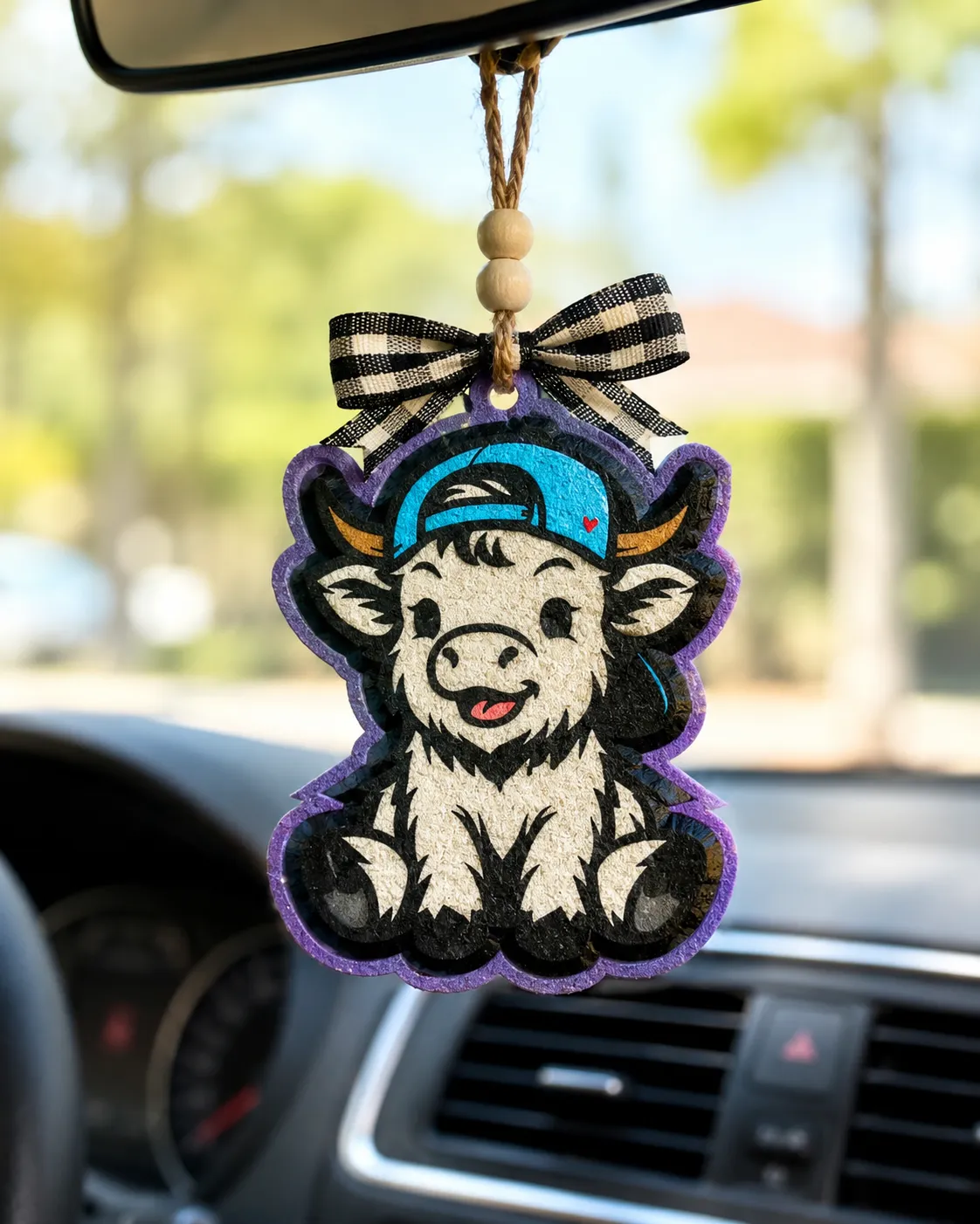 Cute fluffy highland cow shaped aroma bead car freshie air freshener with western country cozy theme hanging from a string